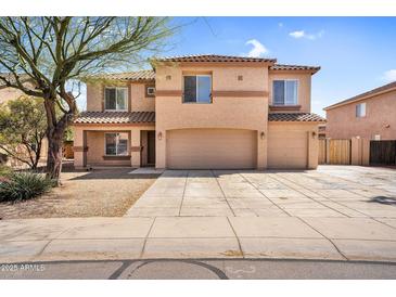 Two-story home featuring a three-car garage and a desert-landscaped front yard under a sunny blue sky at 3423 E Superior Rd, San Tan Valley, AZ 85143