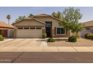 Charming single-story home featuring a two-car garage and desert landscaping for easy maintenance at 3905 E Derringer Way, Gilbert, AZ 85297