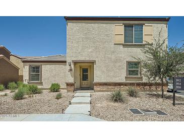 Two-story home with a neutral color, low maintenance desert landscaping, and a well-lit entryway at 3916 S 79Th Ln, Phoenix, AZ 85043