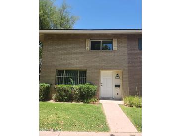Charming two-story home with a well-maintained front yard and classic brick facade at 4533 N 17Th Ave, Phoenix, AZ 85015