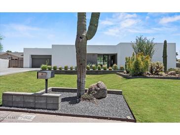 Contemporary home showcasing a well-maintained lawn and desert landscaping at 5301 N 43Rd St, Phoenix, AZ 85018