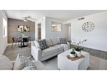 Modern living room with stylish furniture, gray flooring, and decorative accents at 616 S Hardy Dr # 203, Tempe, AZ 85281