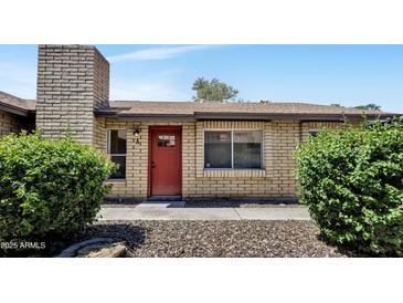 Charming single-story home with a red front door, brick facade, and well-maintained landscaping at 6415 S Newberry Rd # A, Tempe, AZ 85283