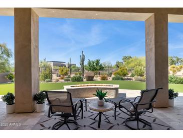 Inviting back patio with comfortable seating and a cozy fire pit, perfect for outdoor relaxation at 6450 E Monterra Way, Scottsdale, AZ 85266
