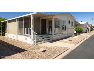 Charming single-story home with a screened-in porch, easy-care landscaping, and convenient covered parking at 11596 W Sierra Dawn Blvd # 182, Surprise, AZ 85378