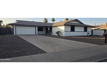 Charming single-story home featuring a well-manicured front yard, long driveway, and an attached two-car garage at 3810 W Yucca St, Phoenix, AZ 85029