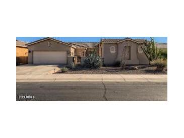 Charming single-story home with desert landscaping and a two-car garage at 42625 W Sandpiper Dr, Maricopa, AZ 85138
