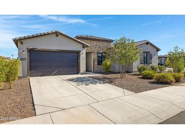 Charming single-story home with stone accents, a two-car garage, and a well-manicured front yard at 8027 W Northview Ave, Glendale, AZ 85303