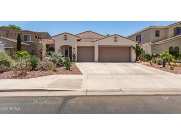 Charming single-story home with desert landscaping, a tile roof, and a spacious two-car garage at 10449 E Jacob Ave, Mesa, AZ 85209