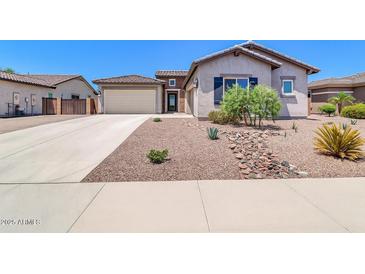 Charming single-story home featuring desert landscaping, a two-car garage, and a neutral color palette at 10664 E Ellis St, Mesa, AZ 85207