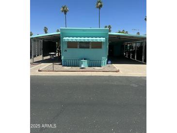 Charming turquoise mobile home with carport and small landscaped yard at 150 S Windsor Dr # 35, Mesa, AZ 85204