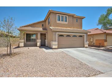 Charming two-story home featuring a neutral color palette, tile roof, and a two-car garage at 4318 W Apollo Rd, Laveen, AZ 85339