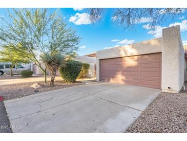Charming single-story home with a private driveway and desert landscaping, offering convenient parking and curb appeal at 1913 S River Dr, Tempe, AZ 85281