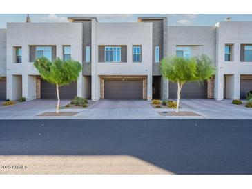 Charming townhome showcasing neat landscaping and a well-maintained facade, creating a welcoming curb appeal at 1956 W Kinfield Trl, Phoenix, AZ 85085