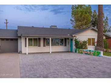 Charming single-story home featuring a well-manicured yard, a stylish brick driveway, and vibrant curb appeal at 4036 N 40Th Pl, Phoenix, AZ 85018