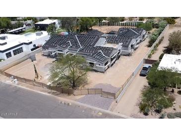 A construction project shows a multi-unit building with gray roofs and light siding surrounded by fencing at 6426 E Turquoise Ave, Paradise Valley, AZ 85253
