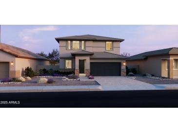 Charming two-story home featuring a modern design, well-maintained landscaping, and an attached two-car garage at 797 W Lark Dr, Queen Creek, AZ 85140