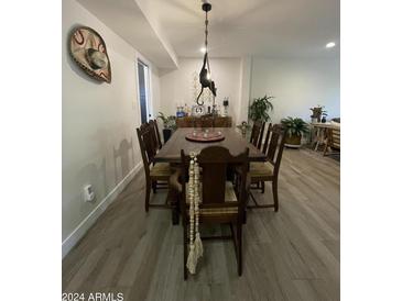 Inviting dining room featuring a unique light fixture and a sombrero on the wall at 12421 N 41St Pl, Phoenix, AZ 85032