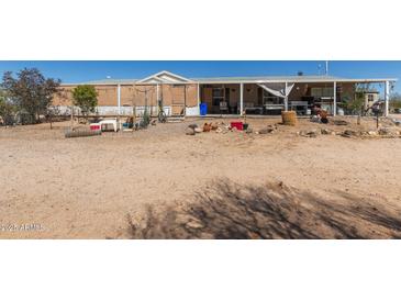 Exterior shot of the home with a porch and desert landscaping at 1347 S Oak Rd, Maricopa, AZ 85139
