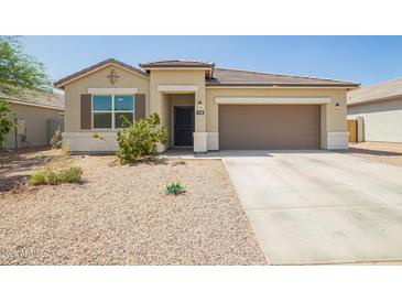 Charming single-story home with well-maintained landscaping, a two-car garage and inviting curb appeal at 1748 W Cameron Blvd, Coolidge, AZ 85128