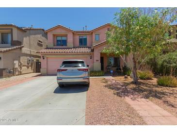Charming two-story home features a well-manicured front yard and a spacious driveway at 19719 N Castille Dr, Maricopa, AZ 85138