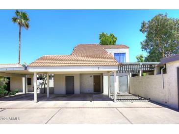 Charming home featuring a covered parking area and desert landscaping on a sunny day at 2416 W Caribbean Ln # 2, Phoenix, AZ 85023