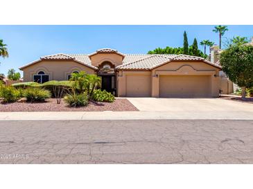 Charming single-story home with well-manicured landscaping and a two-car garage at 3535 E Brookwood Ct, Phoenix, AZ 85048