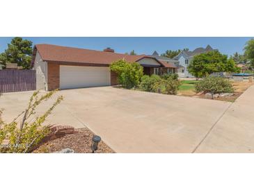 Charming single Gathering home with a spacious driveway and well-maintained landscaping in a suburban neighborhood at 428 S Sunnyvale --, Mesa, AZ 85206