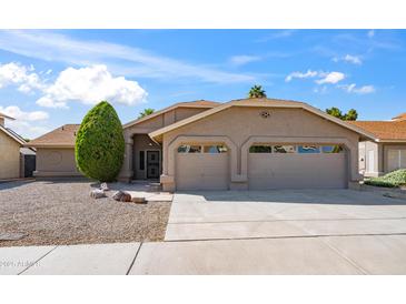 Charming single-story home with a two-car garage, well-maintained landscaping, and a classic desert aesthetic at 4439 W Cielo Grande --, Glendale, AZ 85310