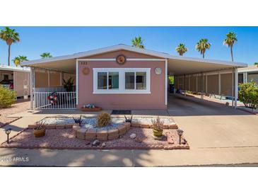 Charming home featuring covered parking and a well-maintained desert-style landscaped front yard at 9302 E Broadway Rd # 122, Mesa, AZ 85208