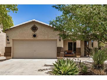 Charming single-story home with a two-car garage and desert landscaping in front yard at 1086 E Canyon Trail --, San Tan Valley, AZ 85143