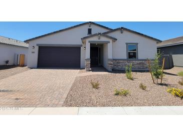 Charming single-story home featuring a stone-accented entrance and a low-maintenance desert landscape at 4811 W Hunter Trl, San Tan Valley, AZ 85144