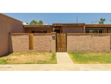 Charming front entrance with secure gated courtyard and nicely maintained landscape at 6008 W Augusta Ave, Glendale, AZ 85301