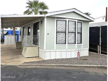 Charming single-story home featuring a covered entrance, white trim, and well-maintained landscaping at 730 S Country Club Dr # 62, Mesa, AZ 85210