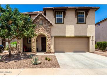 Charming two-story home featuring a stone-accented entrance and a well-maintained front yard at 820 E Constance Way, Phoenix, AZ 85042