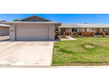 Charming single-story home showcasing a well-maintained lawn and inviting curb appeal at 10651 W Saratoga Cir, Sun City, AZ 85351