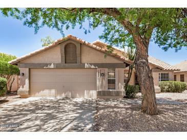 Charming single-story home with a neutral color palette, attached two-car garage, and desert landscaping at 1330 W Butler Dr, Chandler, AZ 85224