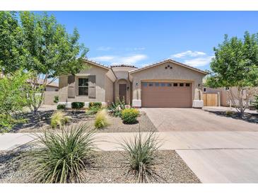 Charming single-story home featuring manicured desert landscaping and a two-car garage at 23038 E Twilight Dr, Queen Creek, AZ 85142