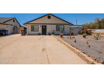 Charming single-story home with a desert landscape front yard and a spacious driveway at 4001 E Apollo Rd, Phoenix, AZ 85042