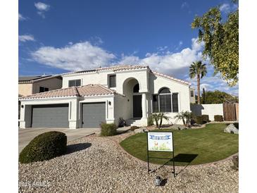Charming two-story home with a well-manicured lawn and desert landscaping in a desirable neighborhood at 6724 W Behrend Dr, Glendale, AZ 85308