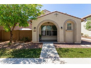 Charming single-story home with an arched porch, desert landscaping, and a welcoming entrance at 9412 S 34Th Dr, Laveen, AZ 85339