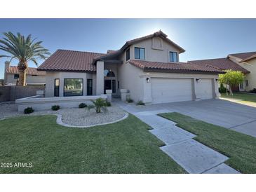 Well-maintained home with three car garage, landscaped front yard, and a tile roof at 1010 N Osprey Ct, Gilbert, AZ 85234