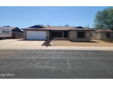 Charming single-story home with a well-maintained yard and an attached two-car garage at 11216 N 52Nd Ave, Glendale, AZ 85304