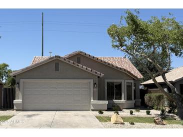 Charming single-story home featuring a two-car garage and well-maintained landscaping at 12586 W Amelia Ave, Avondale, AZ 85392