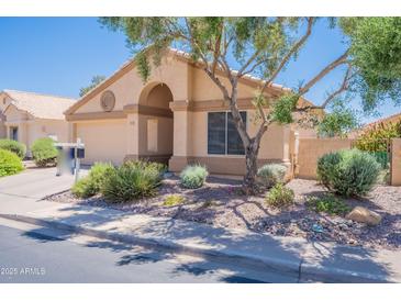 Charming single-story home featuring well-maintained landscaping, a welcoming entrance, and a two-car garage at 17293 N Ponca Way, Surprise, AZ 85374