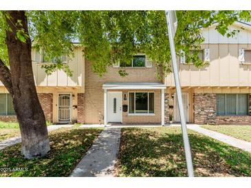 Traditional townhouse with brick and beige exterior and covered front porch, offering classic curb appeal at 18 E Hermosa Dr # 18, Tempe, AZ 85282