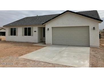 Charming single-story home featuring a two-car garage and low maintenance landscaping at 22343 S Manzanilla Rd, Buckeye, AZ 85326