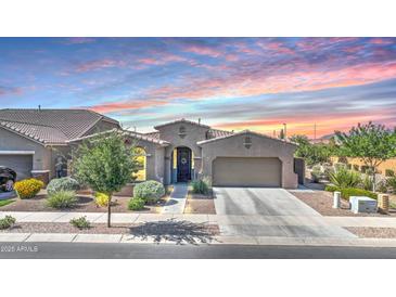 Charming single-story home with desert landscaping and a two-car garage beneath a colorful dusk sky at 22515 E Sonoqui Blvd, Queen Creek, AZ 85142