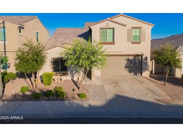 Charming two-story home featuring desert landscaping, neutral stucco, and a two car garage at 2361 N 212Th Dr, Buckeye, AZ 85396