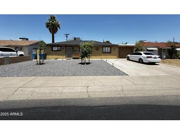 Charming single-story home featuring desert landscaping, a covered entryway, and a paved driveway at 2726 W Butler Dr, Phoenix, AZ 85051
